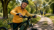 Senior woman adjusting e-bike speed control on trail