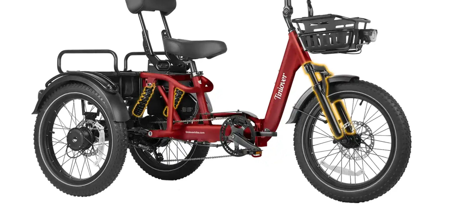 A red three-wheeled electric tricycle with a black seat and backrest, black front basket, gold front suspension fork, and black tires, shown on a plain white background.